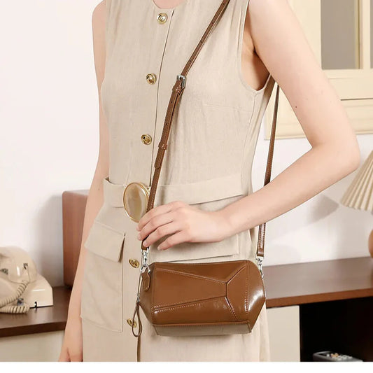 Geometric square silhouette with secure zip — women’s leather crossbody