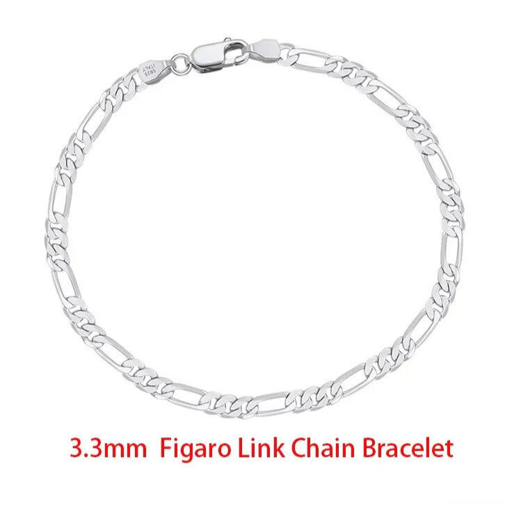 minimalist sterling silver figaro chain bracelet layered with jewellery