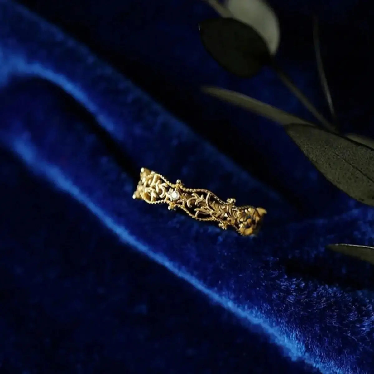 Gold finish sterling silver filigree ring with zircon detail.