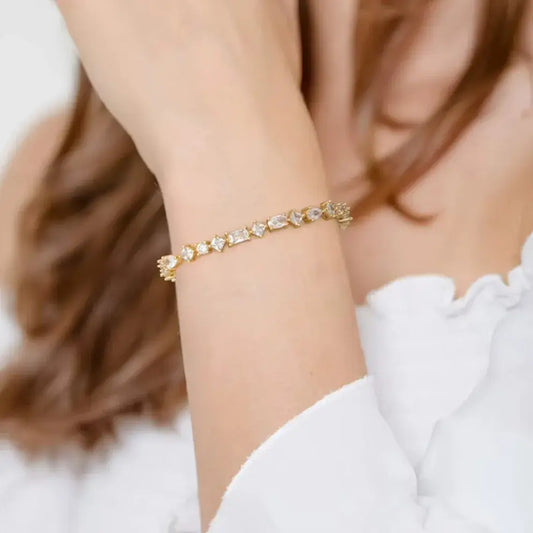 woman wearing gold tennis bracelet with zircon stones