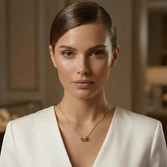 Elegant woman wearing a Gold Rolling Barrel Pendant Necklace in 925 Sterling Silver, styled with a sophisticated blazer for a quiet luxury look.