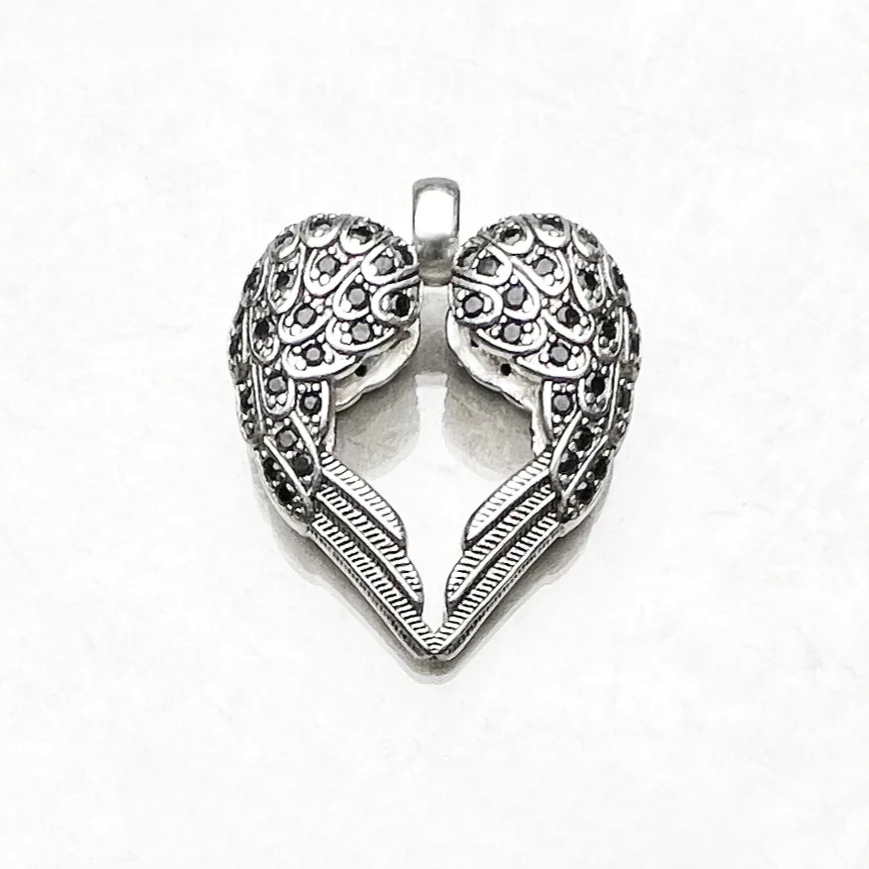 Winged heart pendant in 925 sterling silver on white background