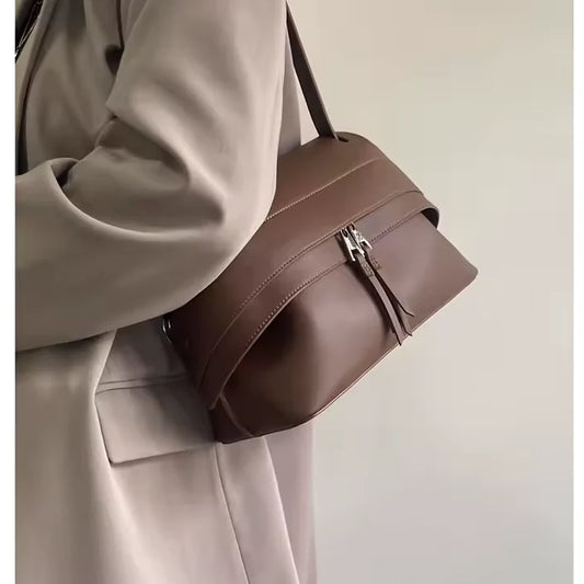brown leather handbag with zip closure and slit pocket