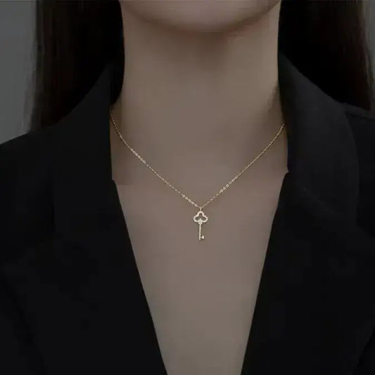 gold clover key necklace close-up