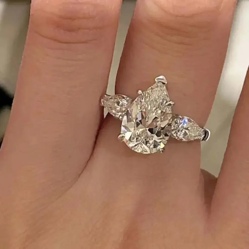 quiet luxury pear-cut moissanite ring on hand