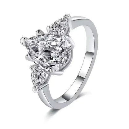 Moissanite Pear Solitaire Ring in Sterling Silver with brilliant-cut cubic zirconia accents on a clean white background.