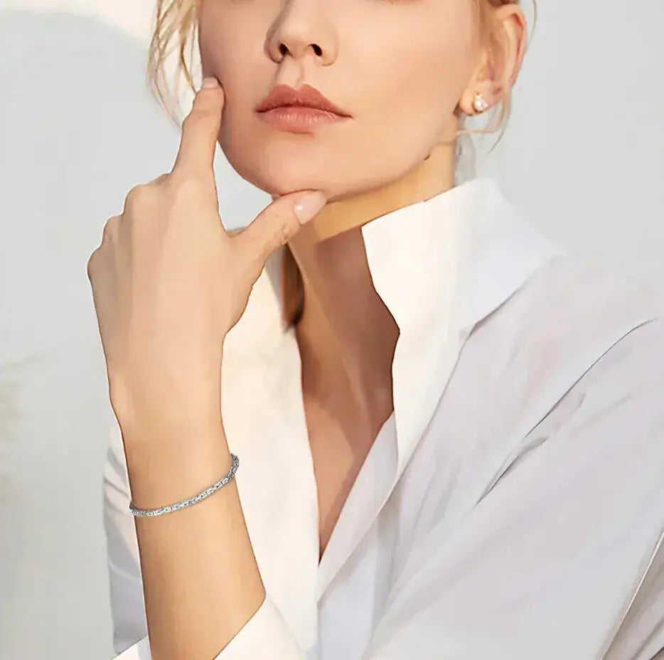woman wearing a silver byzantine chain bracelet with tailored outfit