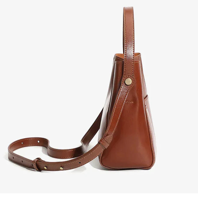 side angle of alira brown soft leather crossbody bag with structured silhouette