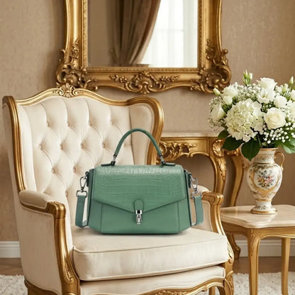 Deep green crocodile-embossed genuine leather satchel bag with top handle.