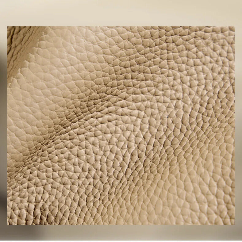 Detailed view of premium leather grain on luxury women’s bucket bag