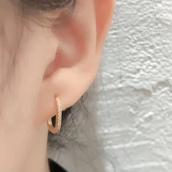 gold zirconia hoops on ear