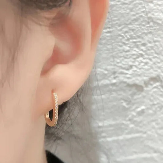 gold zirconia hoops on ear