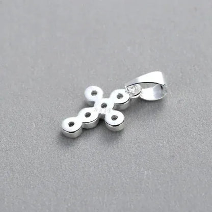 minimalist silver cross pendant with cubic zirconia back view