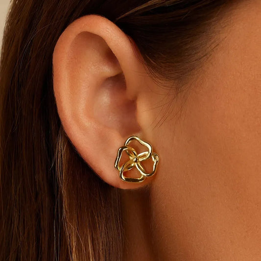 elegantia gold flower studs on model ear