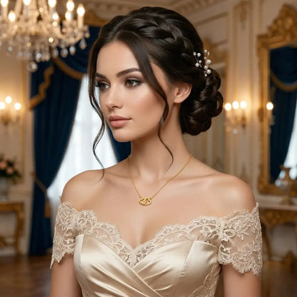 Elegant woman wearing a delicate 18ct gold necklace with two small interlocked hearts featuring side pavé moissanite stones.