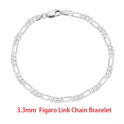 minimalist sterling silver figaro chain bracelet layered with jewellery