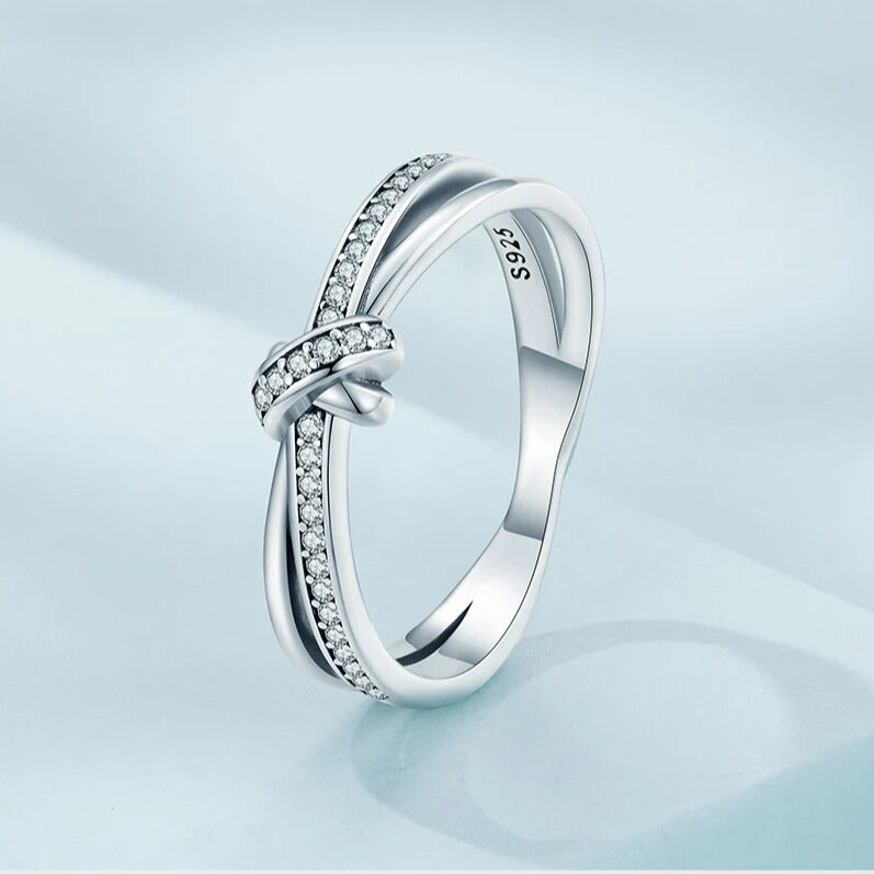Close-up of bezel setting on cubic zirconia knot design ring