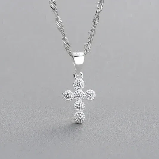 sweet cross shaped silver pendant close up