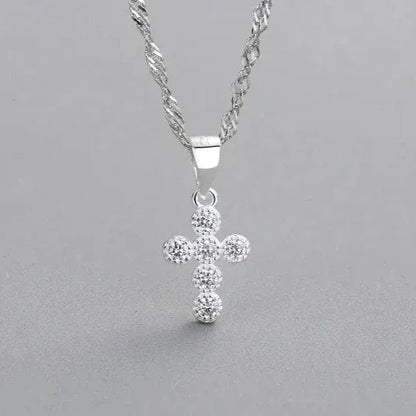 sweet cross shaped silver pendant close up