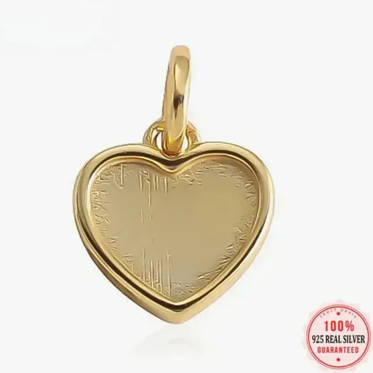 delicate 18K gold heart pendant on neutral fabric