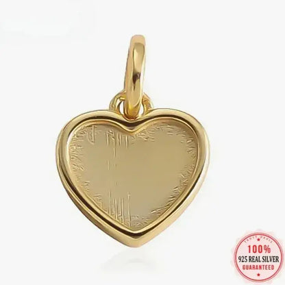 delicate 18K gold heart pendant on neutral fabric