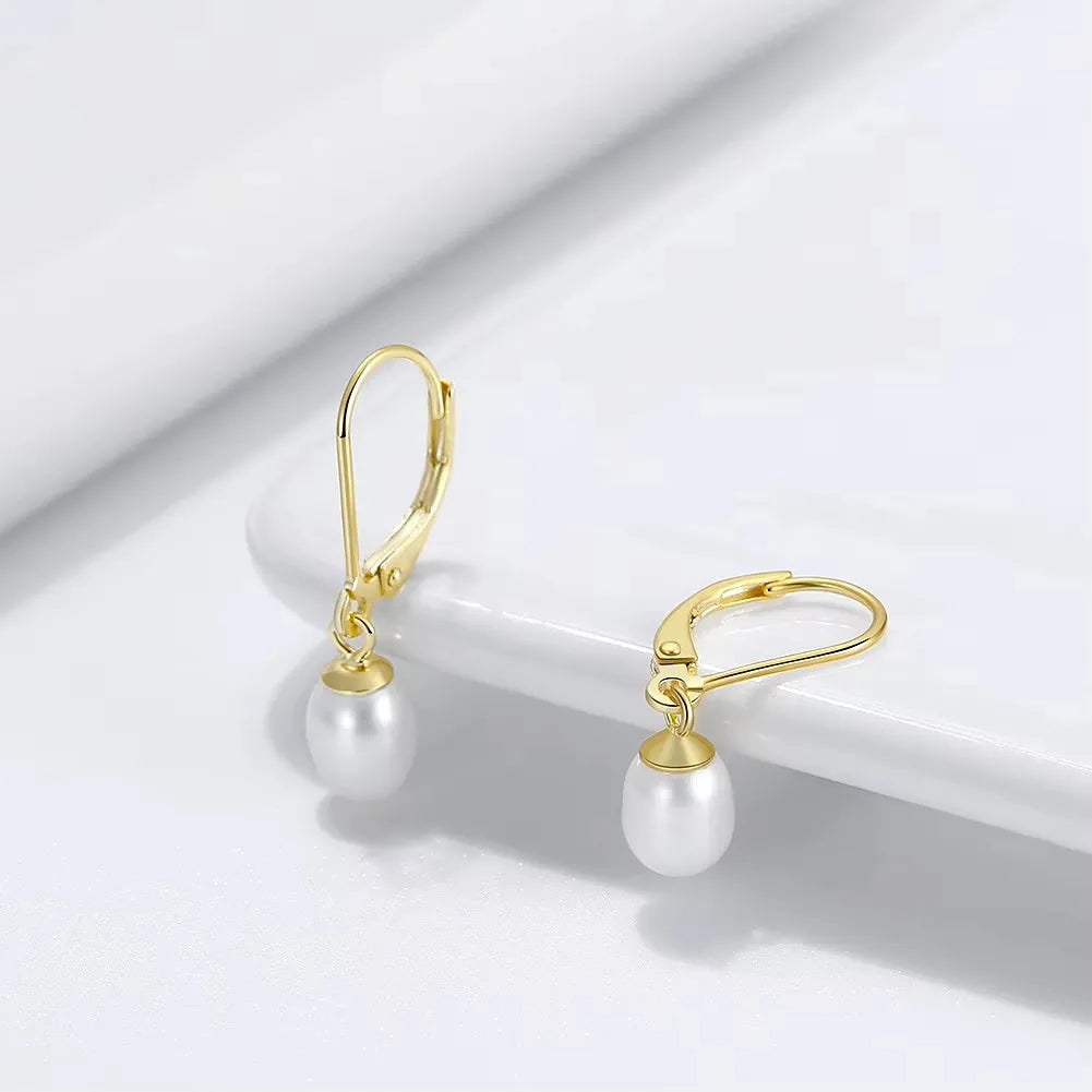 minimalist gold pearl dangle earrings elegantia jewellery uk
