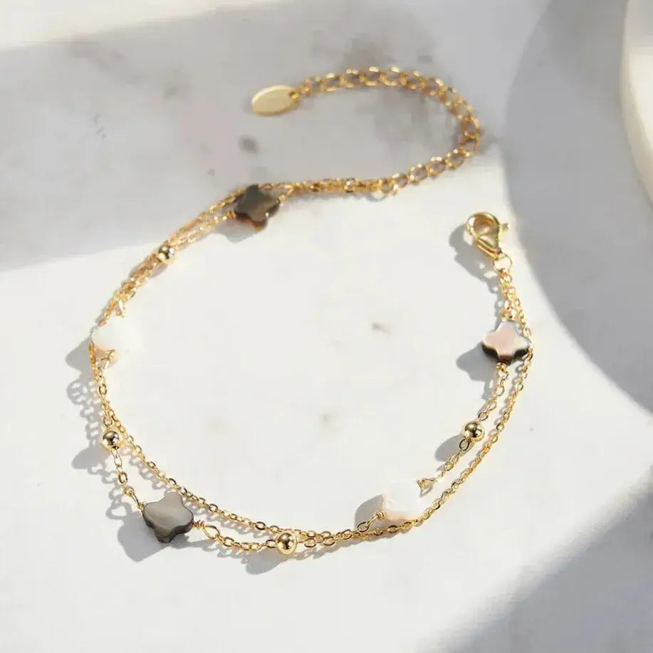 hypoallergenic gold-finish clover bracelet on wrist