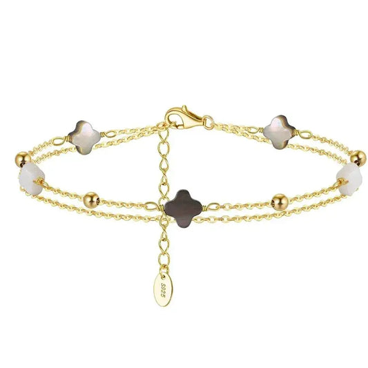delicate gold-finish clover bracelet displayed on soft background