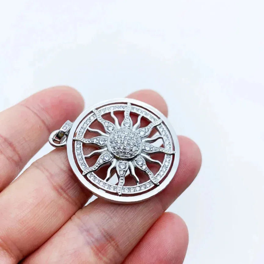 sun motif pendant with white zircon centre close up