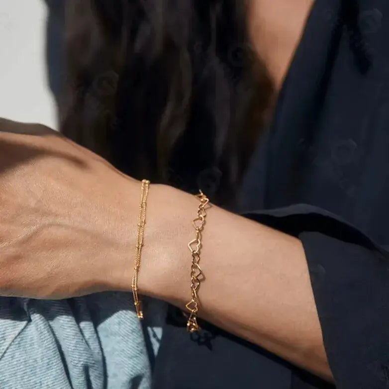 gold heart bracelet styled on wrist — everyday sophistication