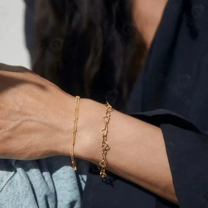 gold heart bracelet styled on wrist — everyday sophistication