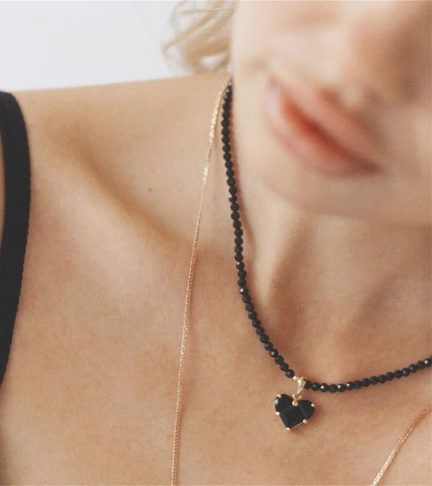 Women’s black crystal necklace featuring heart pendant close-up