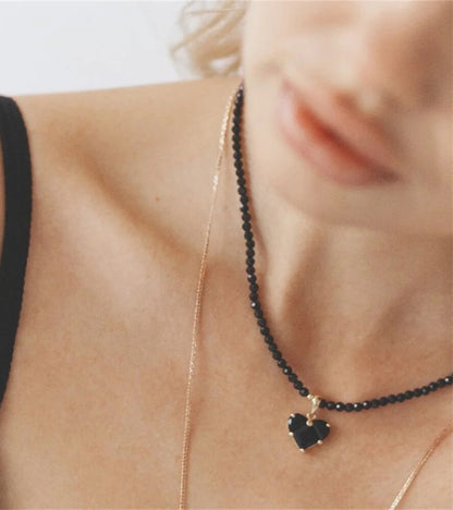 Women’s black crystal necklace featuring heart pendant close-up