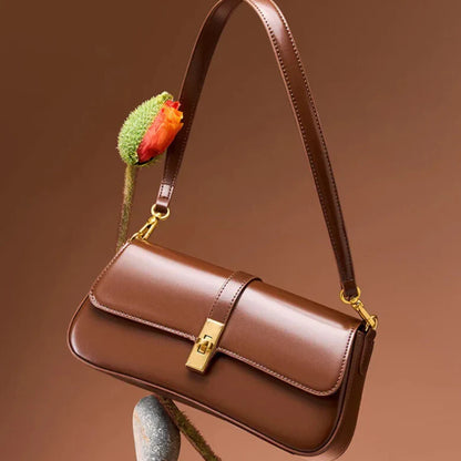 Vintage brown baguette leather handbag for women — angled shot