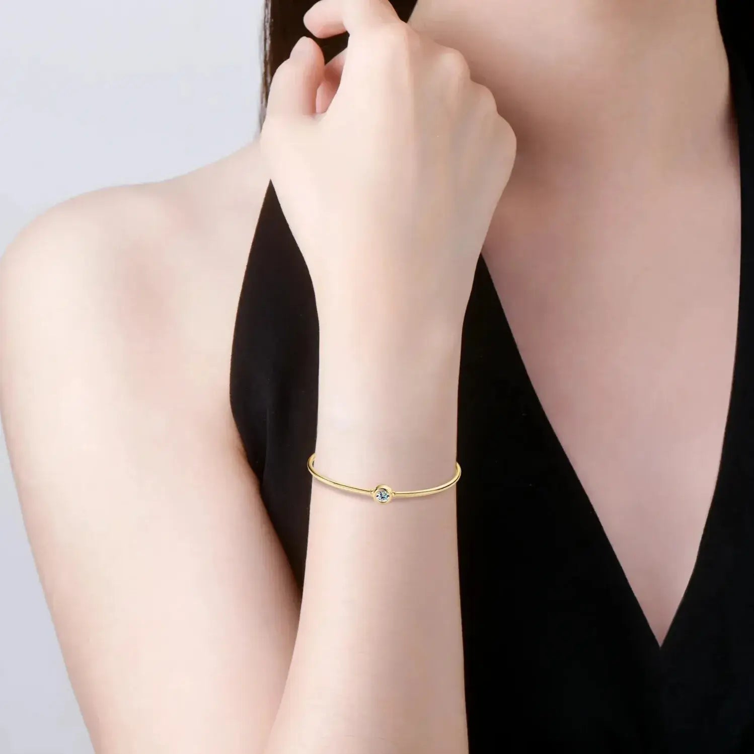 minimalist gold bangle with round cut moissanite