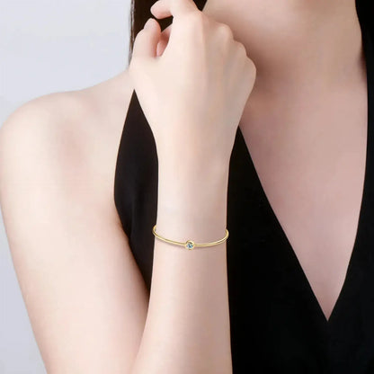 minimalist gold bangle with round cut moissanite