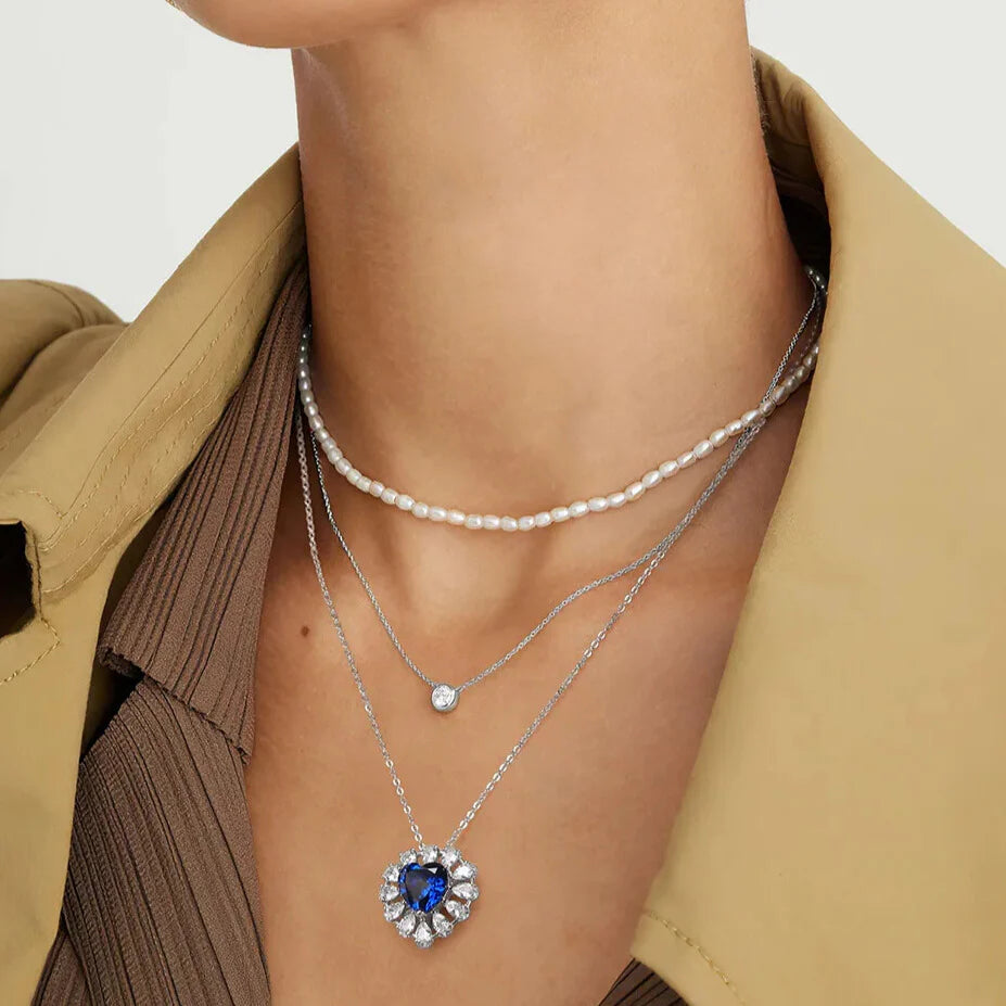 Created sapphire heart with cubic zirconia halo on silver link chain