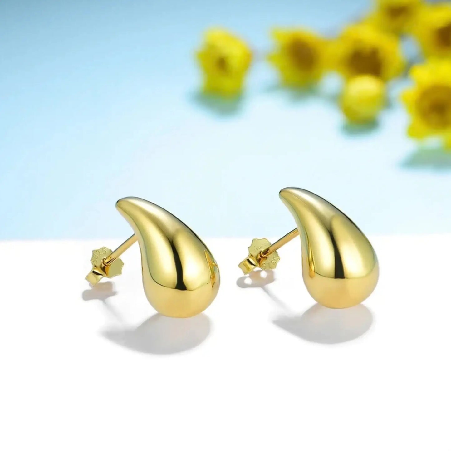 elegant gold teardrop earrings with polished finish, lightweight stud design