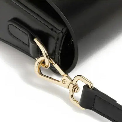 structured black leather crossbody bag with secure closure