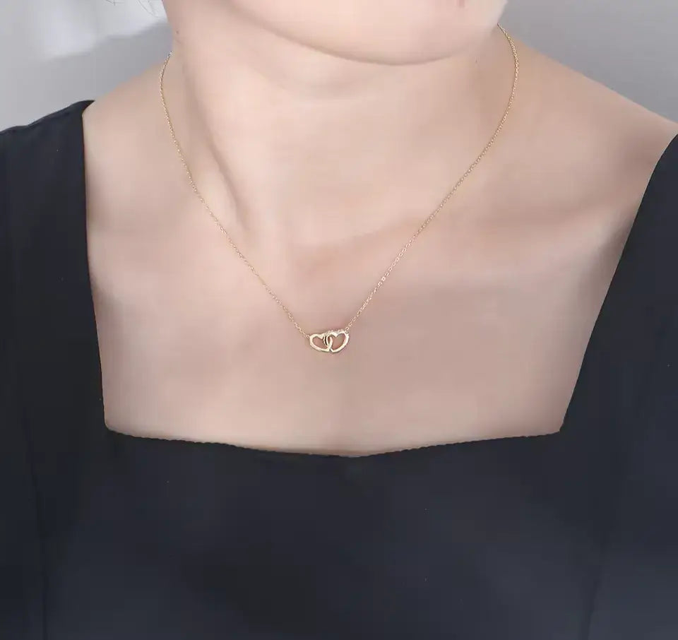 delicate gold heart necklace with vvs moissanite on model