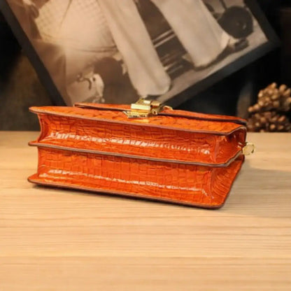 View of the base of the Orange Leather Crossbody Handbag, highlighting the flawless leather finish and the bag’s rigid structure.