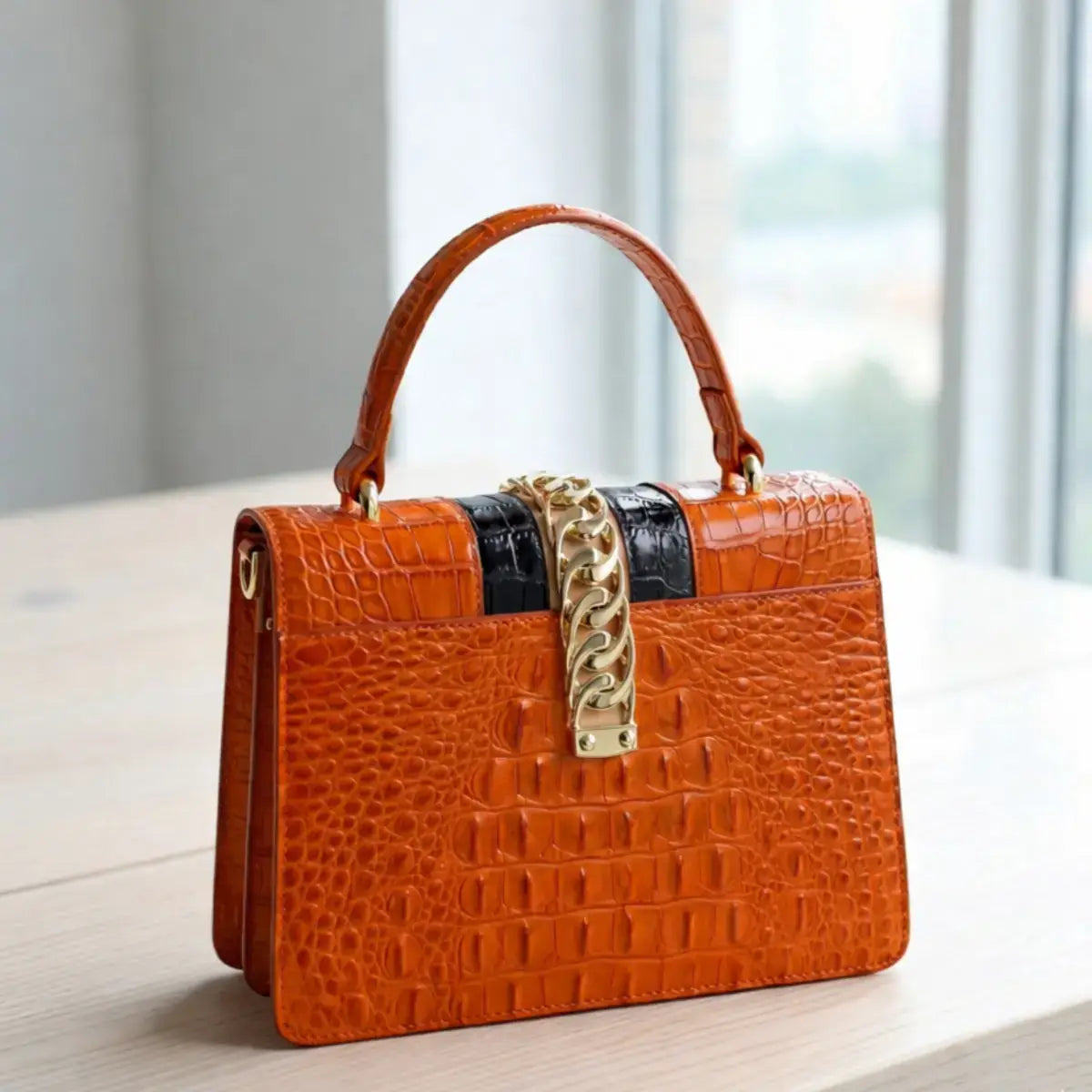 Back view of the base of the Orange Leather Crossbody Handbag, highlighting the flawless leather finish and the bag’s rigid structure.