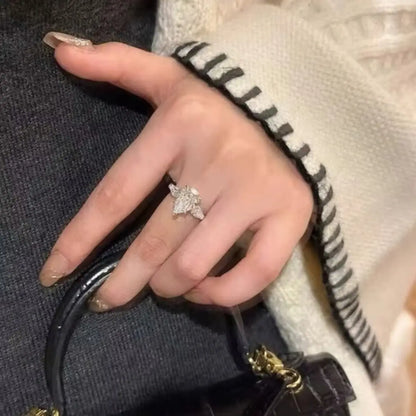 Elegant pear-cut moissanite engagement-style ring in hallmarked 925 silver worn on a finger to show scale and brilliance.