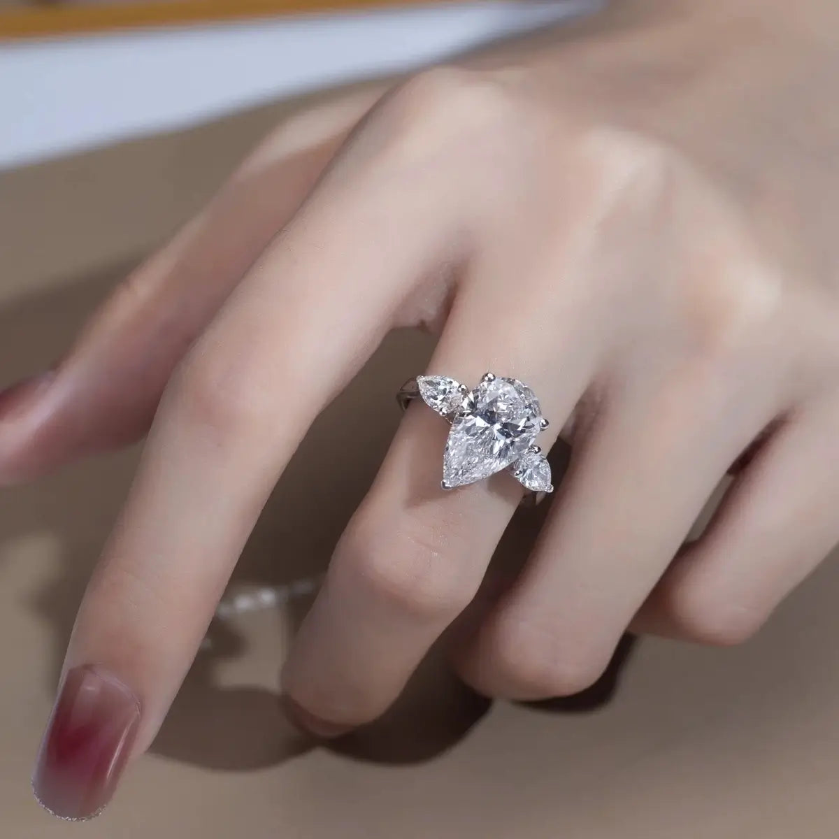 925 sterling silver pear cut ring with high polish finish on model.