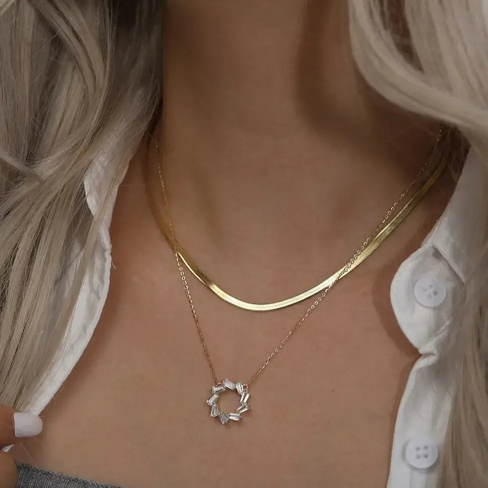 gold geometric pendant necklace on model