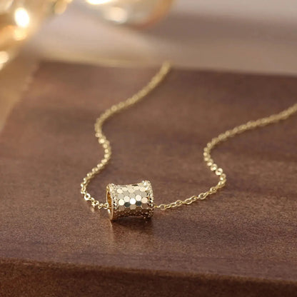 gold tone vintage pendant necklace on marble surface flat lay