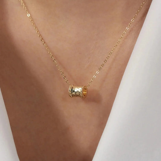 female model wearing gold vintage pendant necklace minimalist outfit