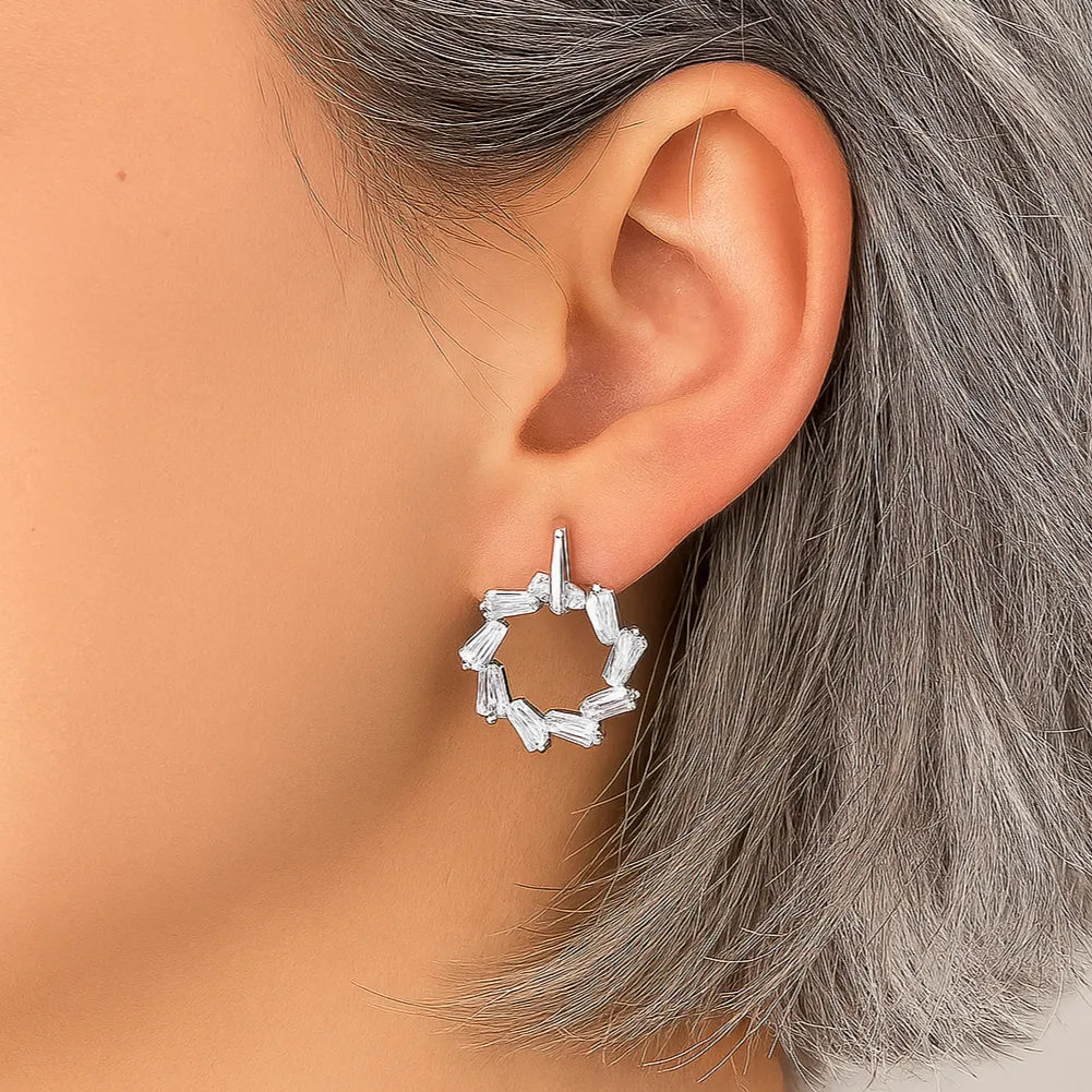 silver geometric drop earrings on ear