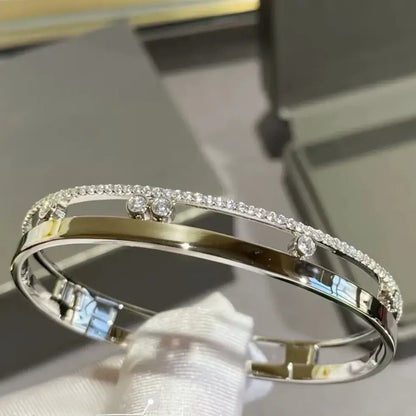 close-up of cubic zirconia stones gliding on sterling silver bracelet