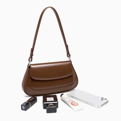 Designer-inspired leather handbag for women — flat lay with essentials